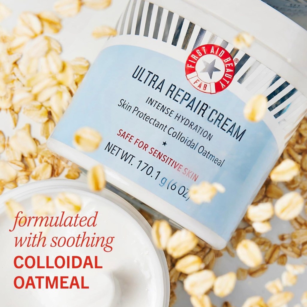 Jar of First Aid Beauty Ultra Repair Cream surrounded by oats, highlighting colloidal oatmeal ingredient.