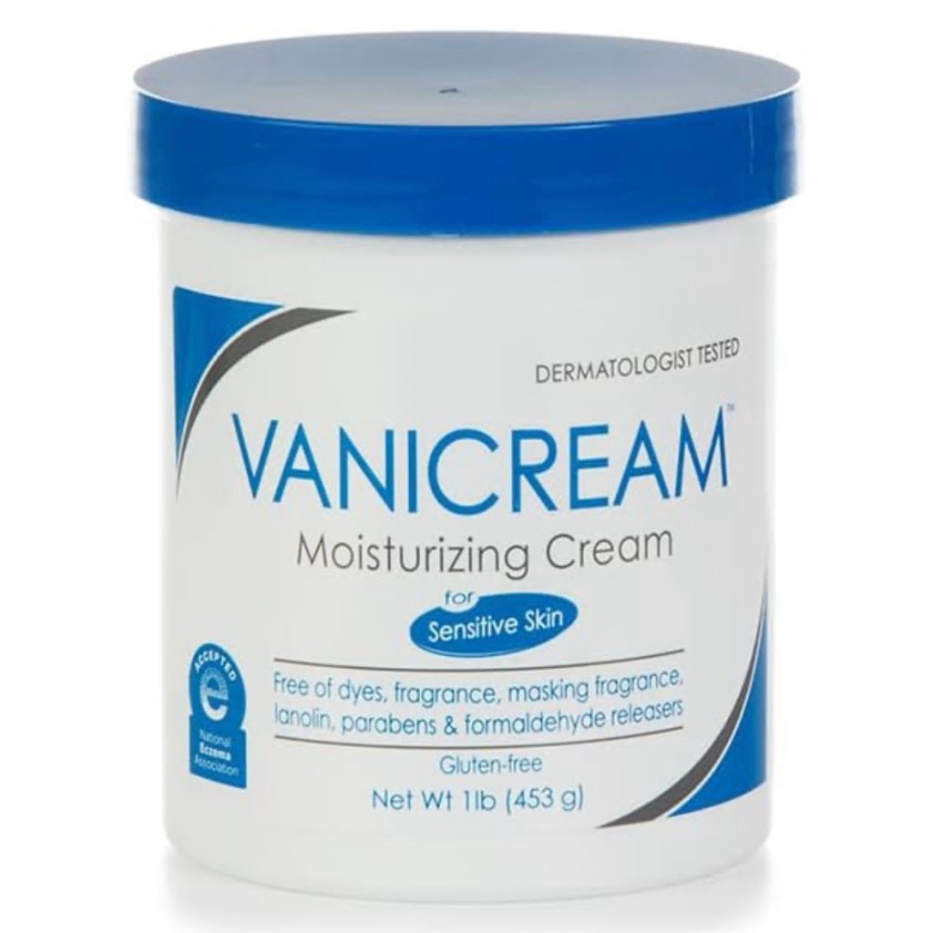 A white tub with a blue lid labeled Vanicream Moisturizing Cream for sensitive skin, showing “free of dyes, fragrance, lanolin, parabens, and formaldehyde releasers.